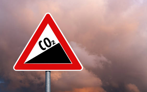 istock CO2 sky road sign danger symbol against dark sky 1558969542