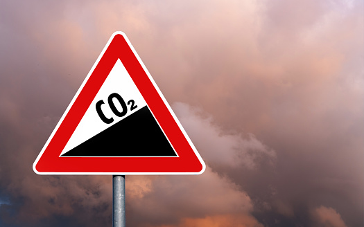 CO2 sky road sign danger symbol against dark sky