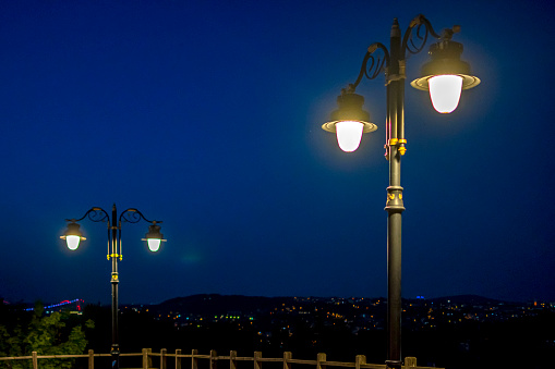 Old fashioned street lamp during rain in the dark