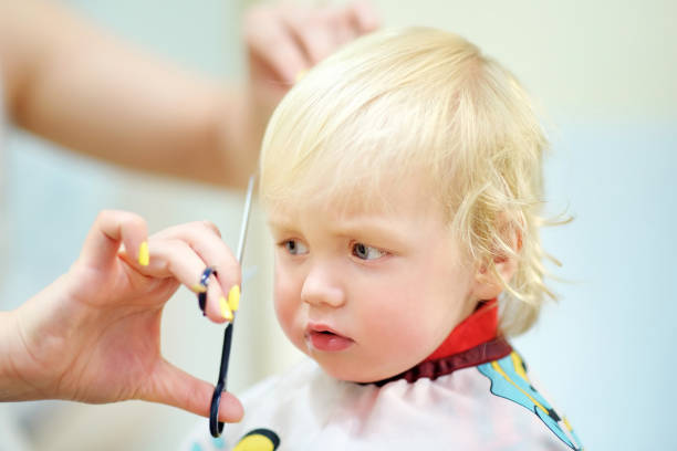 istock Toddler child getting his first haircut 1558990736
