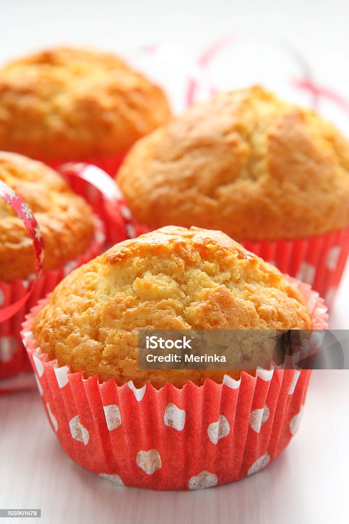 Muffins in red cups on white background Baked Stock Photo