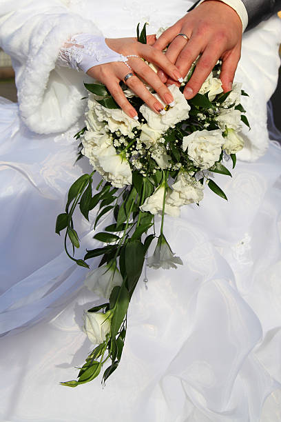 istock Hands and rings on wedding bouquet 155902372