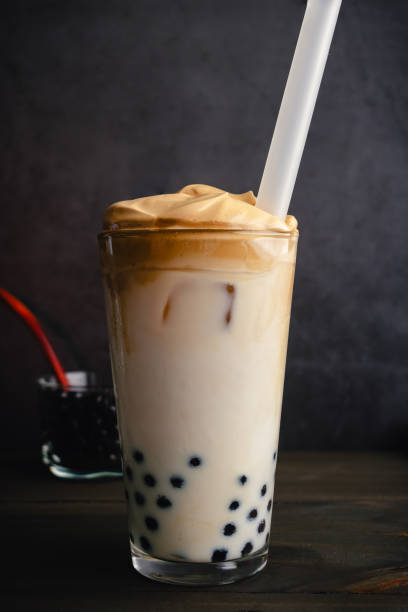 istock Iced Dalgona Coffee with Boba in a Pint Glass on a Dark Background 1559027289