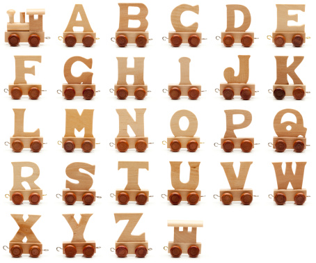 Wooden train alphabet isolated on white.
