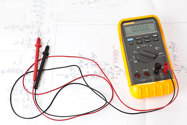 Multitester tool on electronic scheme diagram.  high voltage sign stock pictures, royalty-free photos & images