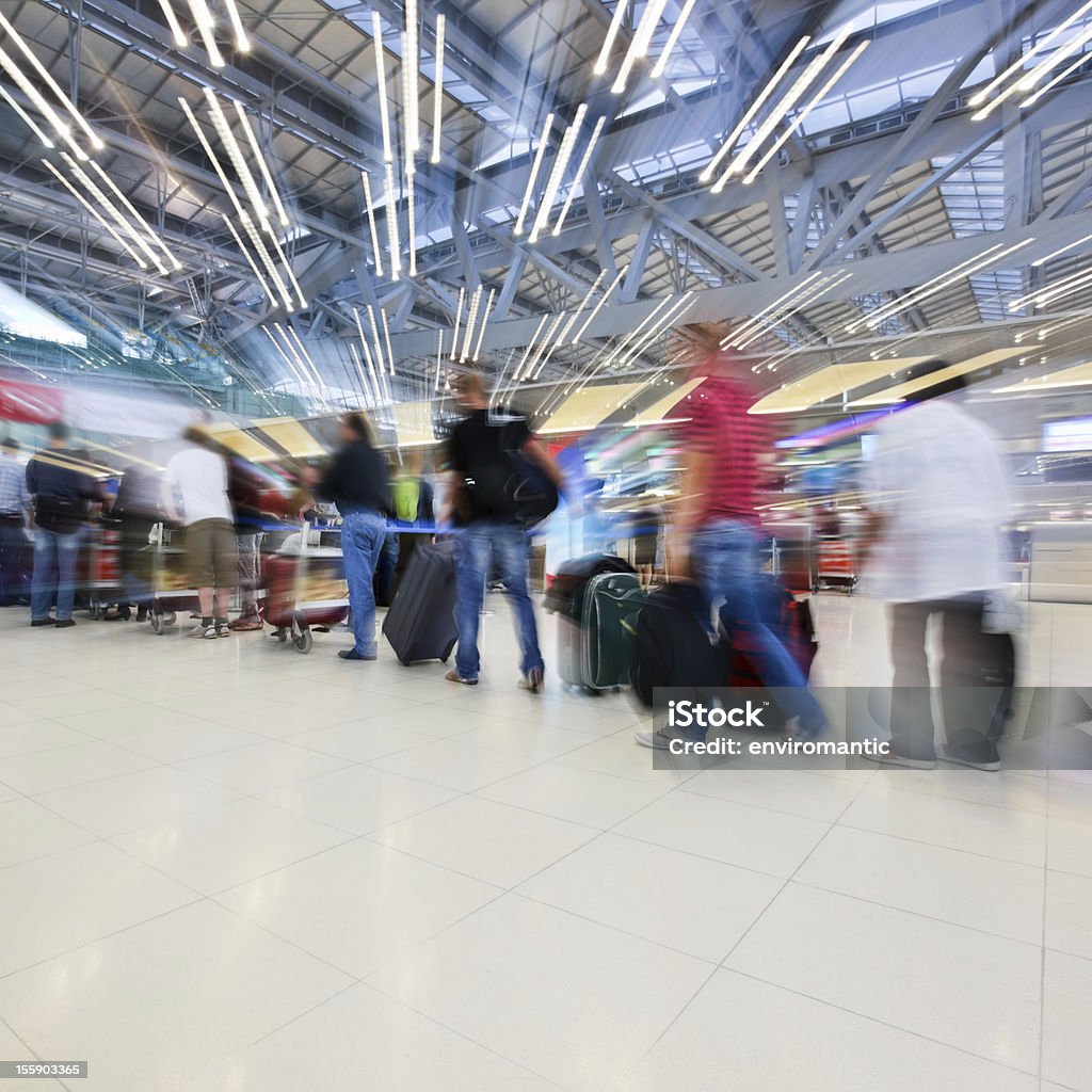 Viaggiatori queing per il check-in presso un aeroporto internazionale. - Foto stock royalty-free di Aeroporto