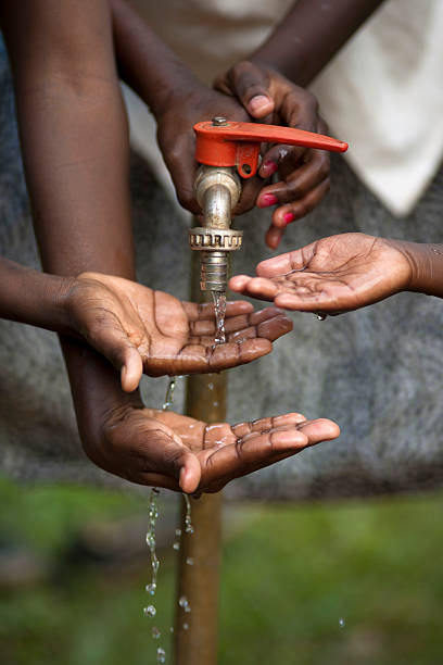 istock Hands of african children with water 155903380