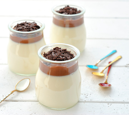Panna cotta with chocolate on a white table