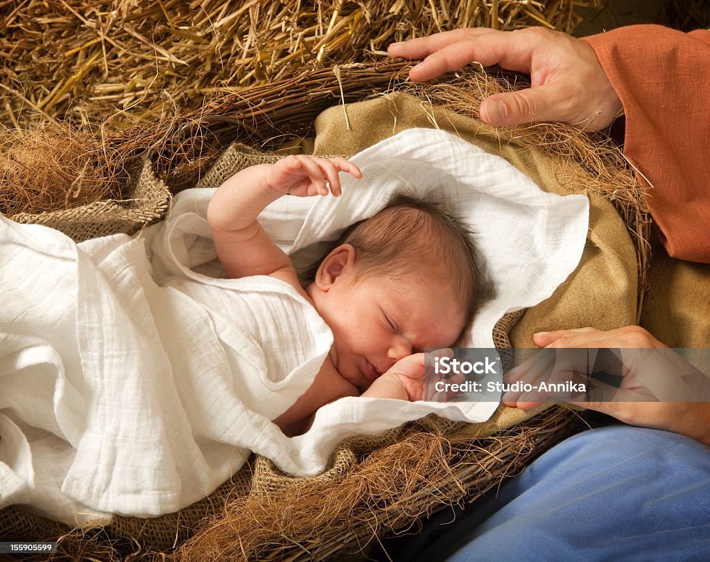 Infant in a manger reenacting birth of Christ 20 days old baby sleeping in a christmas nativity crib Nativity Scene Stock Photo