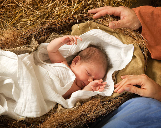 Infant in a manger reenacting birth of Christ 20 days old baby sleeping in a christmas nativity crib nativity scene stock pictures, royalty-free photos & images
