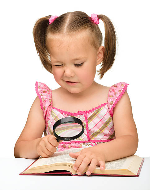 istock Little girl play with book and magnifier 155906231