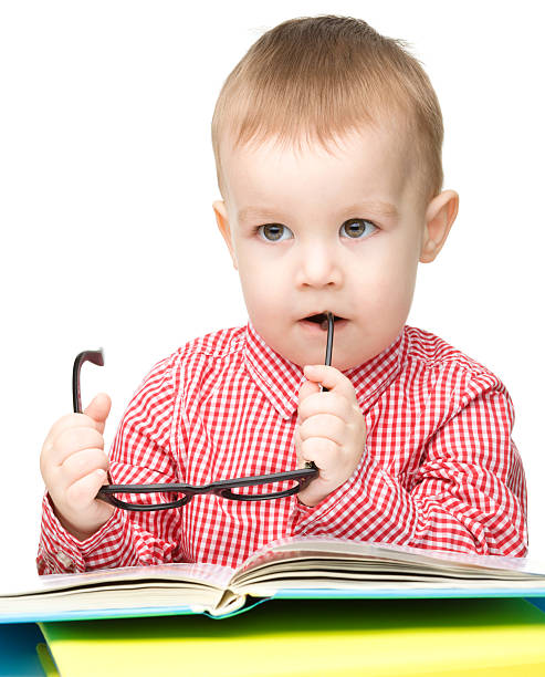 istock Little child play with book and glasses 155906283