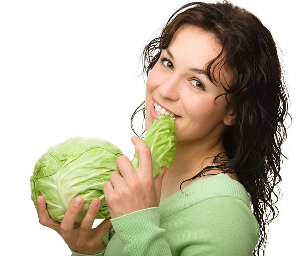 Beautiful young girl with green cabbage stock photo