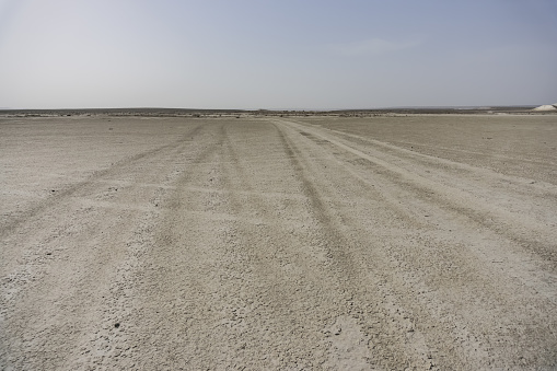Traces from car racing on a dry lake and salt marsh in the Kazakh steppe, a panorama of the desert and the dry bottom of the lake