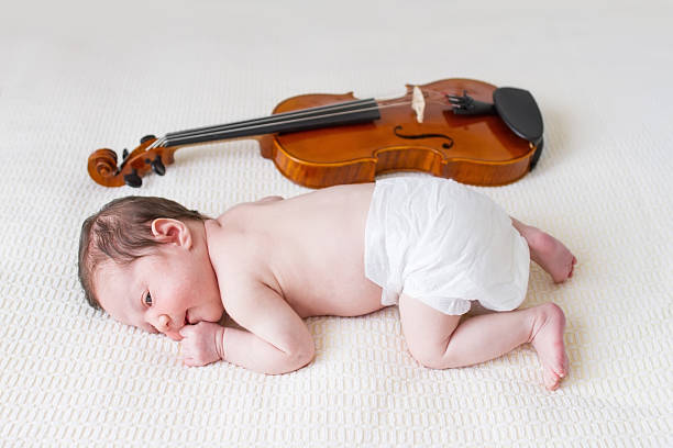 istock Baby girl next to violin 155907240
