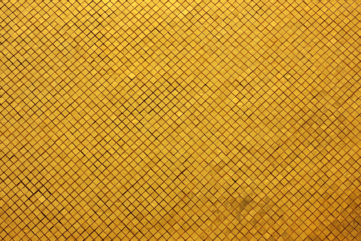 Gold tile mosaic background at an ancient Thai Buddhist temple, Bangkok, Thailand.