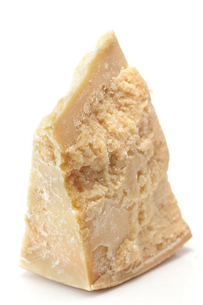 Piece of Italian Parmesan Cheese Close up picture of a piece of italian parmesan cheese on white background parmesan stock pictures, royalty-free photos & images
