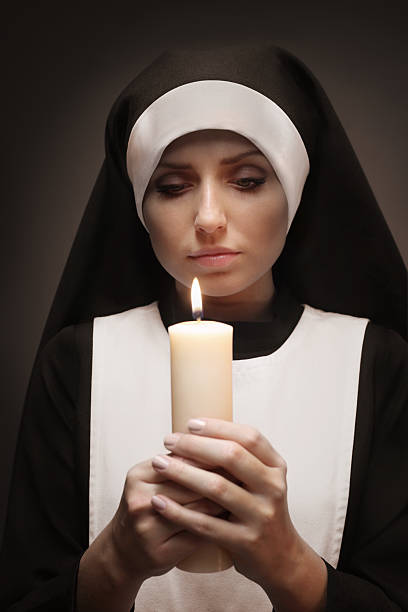 istock Young Nun With Shining Candle 155908702