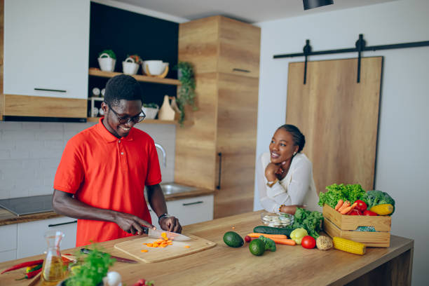 istock Young black chef preparing food for date in the kitchen 1559087632