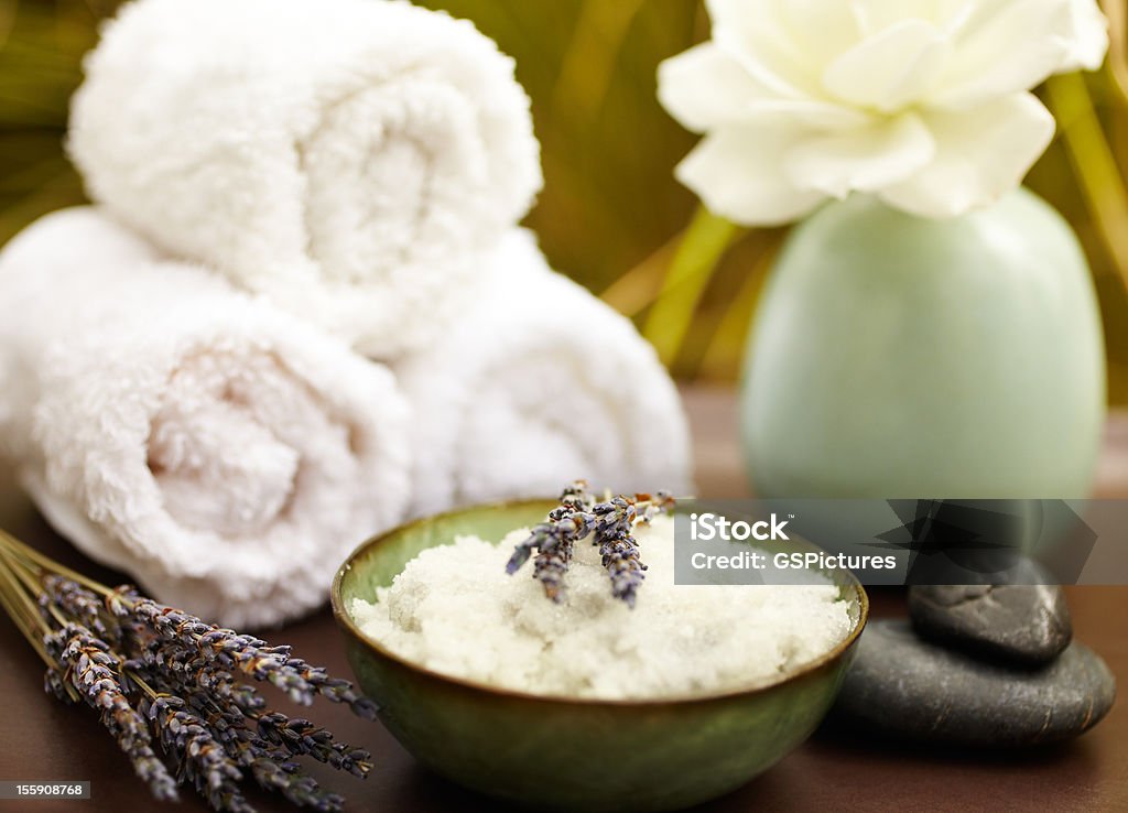 Exfoliation salt scrub at spa with lavender Exfoliation salt scrub at spa with lavender, towels and pebbles Wellbeing Stock Photo