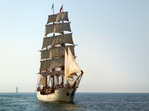 Tall Ship At Sail on Sunny Morning.  Another tall ship is off on the horizon. There is copy space at right.