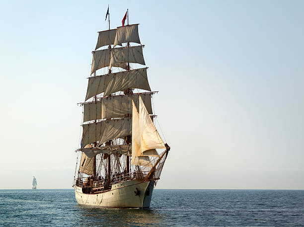 Tall Ship At Sail on Sunny Morning Tall Ship At Sail on Sunny Morning.  Another tall ship is off on the horizon. There is copy space at right. sailing ship stock pictures, royalty-free photos & images