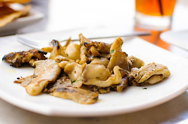 Oyster mushrooms are grow in a shelf-like stacks on logs and up the trunks of living trees.  They are one of the most commonly eaten varieties of mushroom.