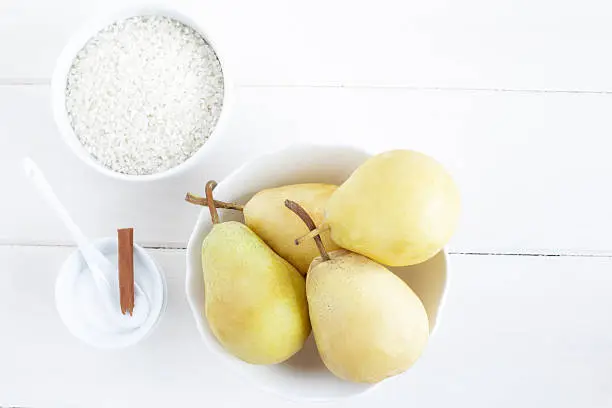 Ingredients for a rice pudding dessert: pears, rice pudding, sugar.