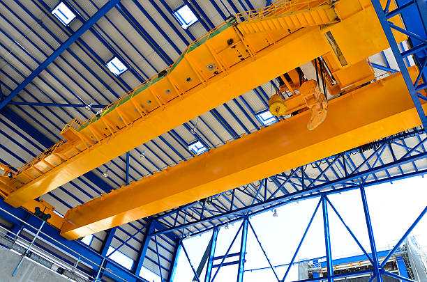 Overhead yellow crane in industrial scenery stock photo