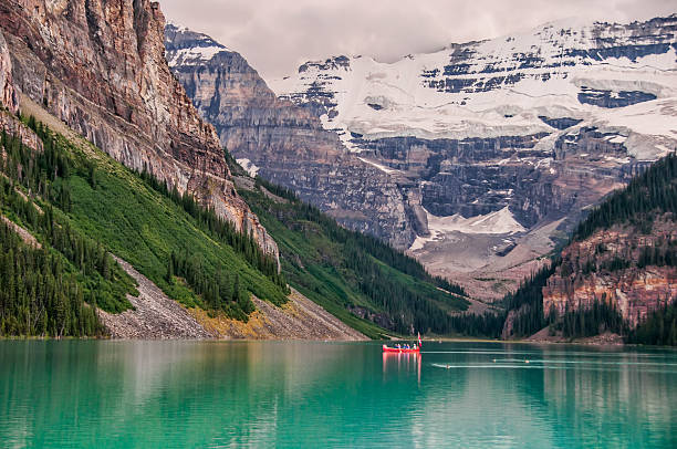 istock Lake Louise Canoe With Glacier 155911413