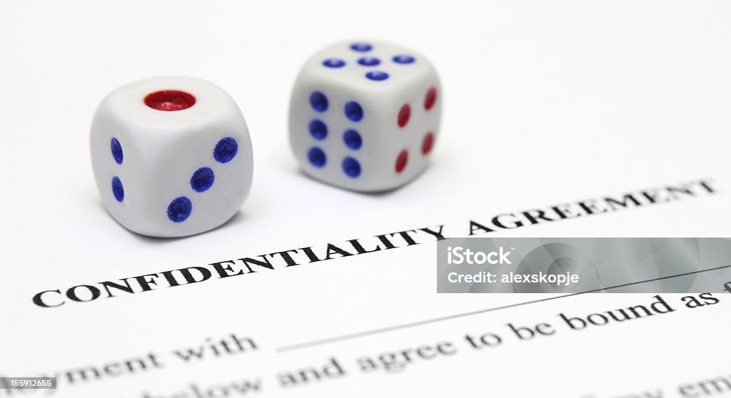Confidential agreement Close up of dice on Confidential agreement form Form - Document Stock Photo