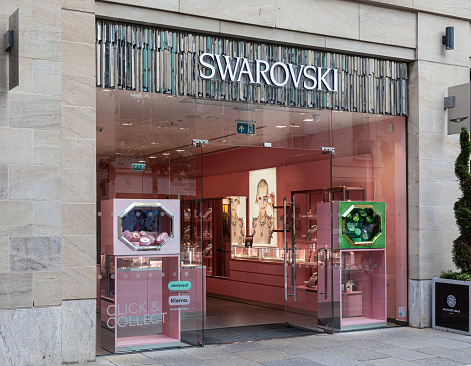 Edinburgh, Scotland, UK - 19th July 2023: Front of and open entrance to the Swarovski shop in Multrees Walk, in the city centre. Swarovski Crystal Business is an Austrian company which manufactures and sells crystal jewellery and accessories.