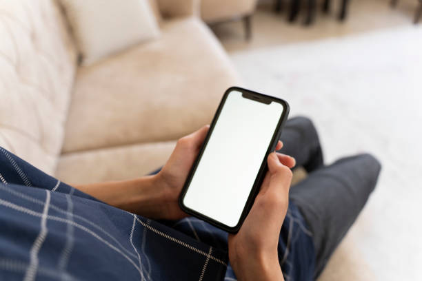 istock Mockup image of a man holding a mobile phone. 1559139427