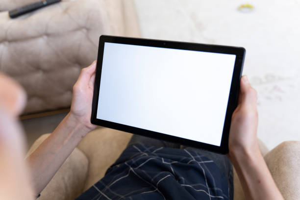 istock Mockup image of a man holding a smart tablet. 1559144574