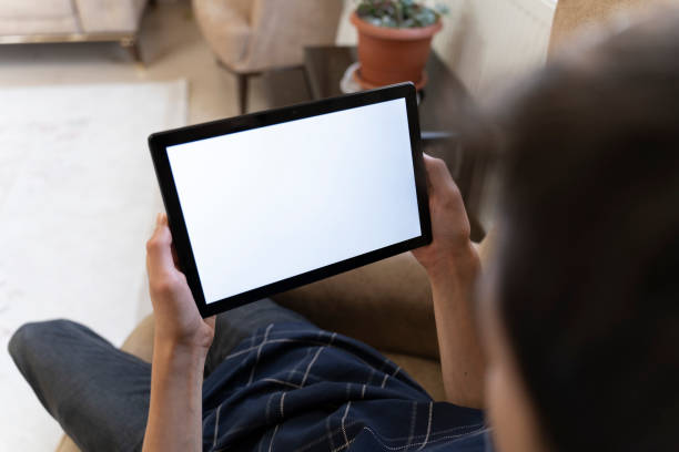 istock Mockup image of a man holding a smart tablet. 1559146622
