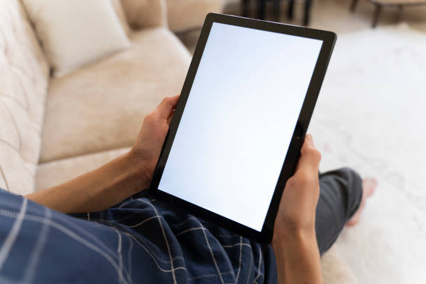 istock Mockup image of a man holding a smart tablet. 1559146623