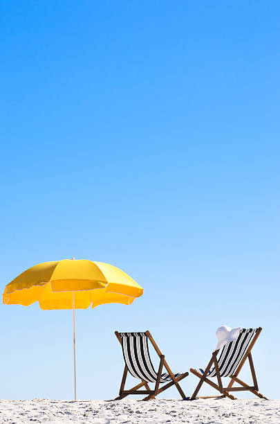 istock Paradise at the beach with folding chairs and an umbrella 155915220