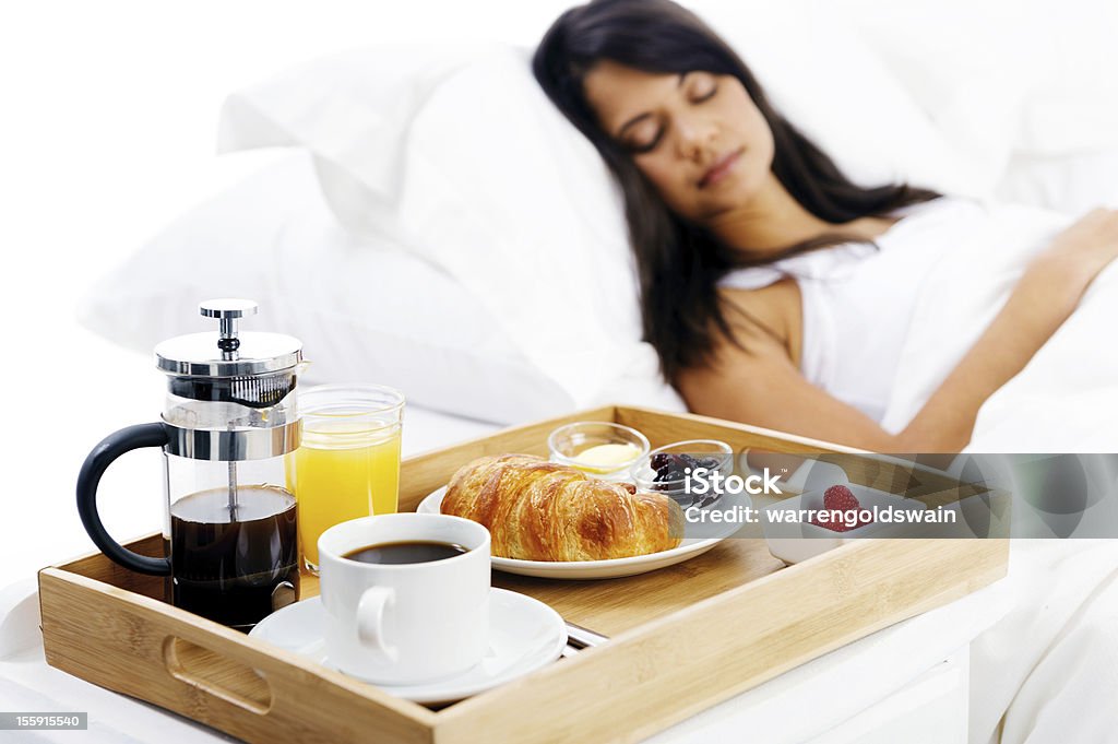 breakfast in bed service bed and breakfast for attractive young woman sleeping and relaxing with room service isolated on white background Adult Stock Photo