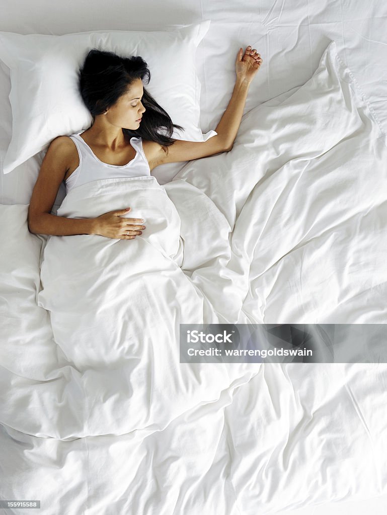 sleeping beauty lonely woman in bed missing her partner overhead view of sleeping beauty Sleeping Stock Photo