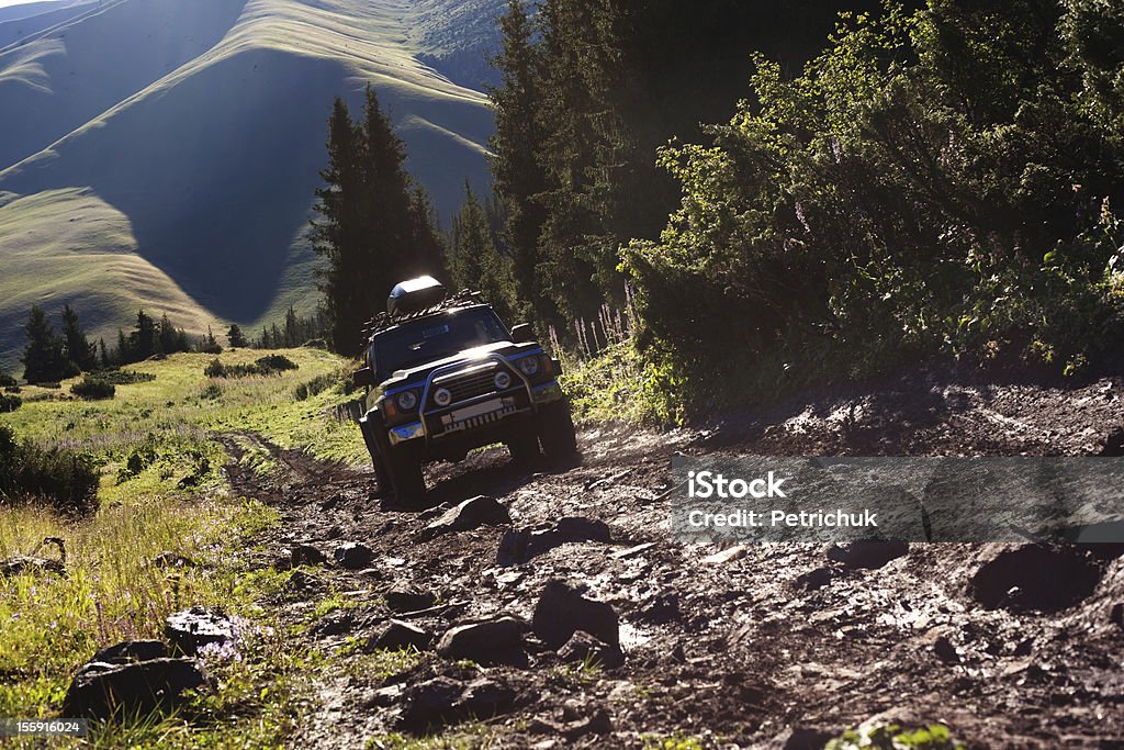 Jeep navigating rough terrain during an off-road drive Off-road. 4x4 jeep tries to climb up top of a hill Off-Road Vehicle Stock Photo