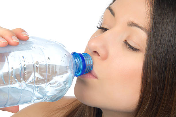 istock Woman drinking water from blue aqua bottle 155917427