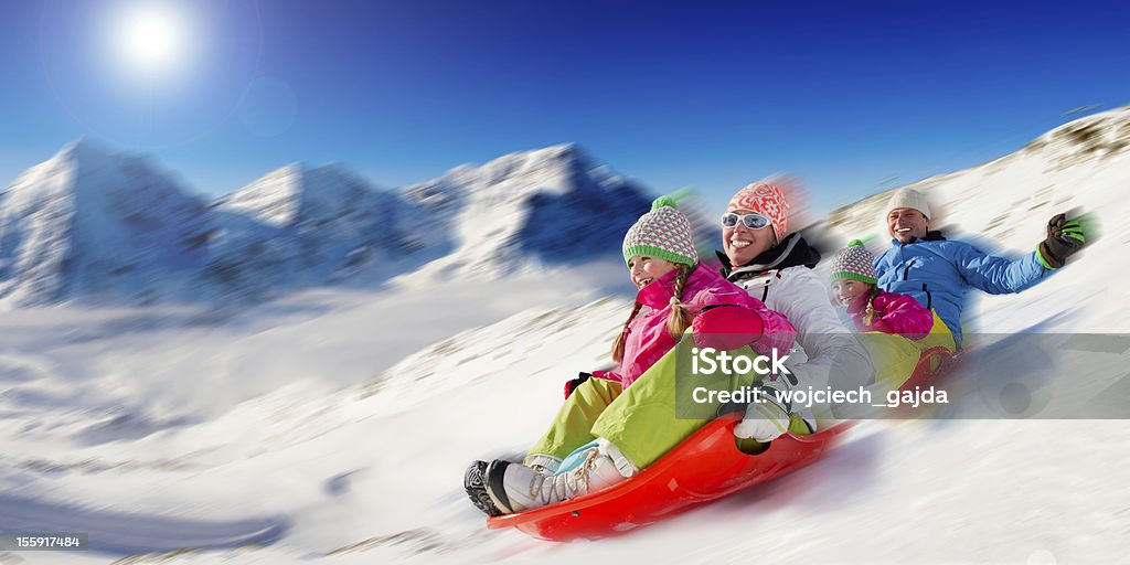 Family sledding Family sledding at winter time Family Stock Photo