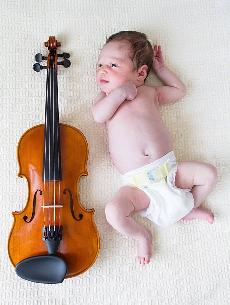 istock Baby girl next to violin 155917814