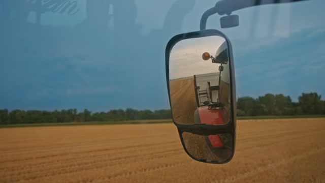 SLO MO Harvest Reflections: Close-Up Rear View Mirror of the Combine Harvester