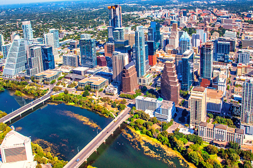 Aerial view of the buildings along the banks of the Colorado River in beautiful and modern downtown Austin, Texas from about 1000 feet in altitude.