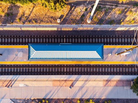 Well-kept transit hub, distant mountains, balmy day, scenic beauty, aerial perspective.