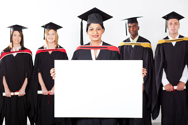 istock female indian graduate holding white board 155920098