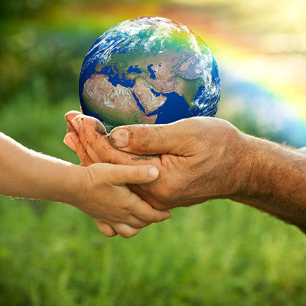 Earth Senior man and baby holding the Earth in hands against a rainbow in spring. Earth maps from: shadedrelief.com Licencing: shadedrelief.com/natural2/pages/use.html green environment friendly stock pictures, royalty-free photos & images