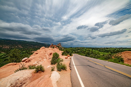 Dramatic clouds and Massive red sandstone rock formations in the Garden of the Gods in Colorado Springs, Colorado in western USA of North America
