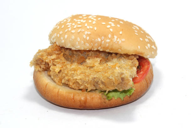 Male chef wrapping take out burger
